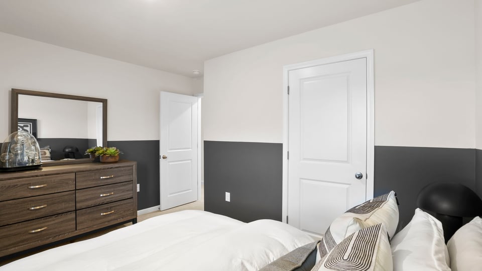 Bedroom with carpet and windows.