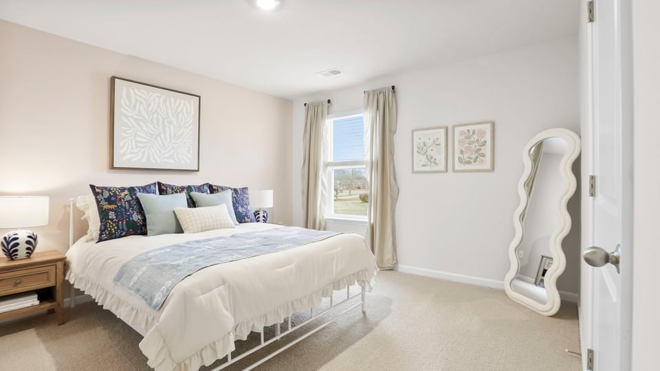 Bedroom with carpet and windows.