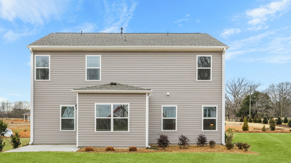 Back exterior with large backyard.