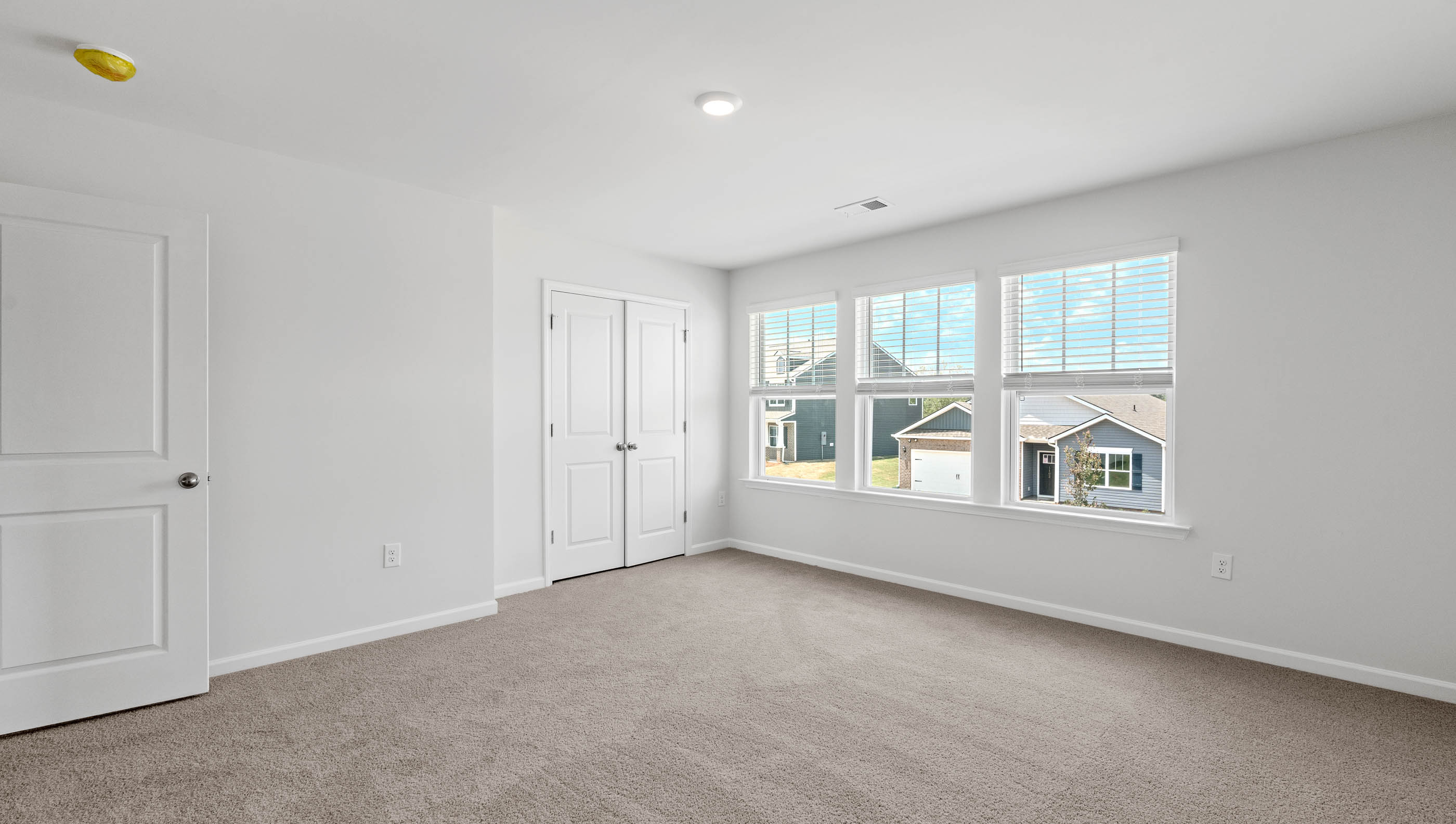 Bedroom with carpet and window.