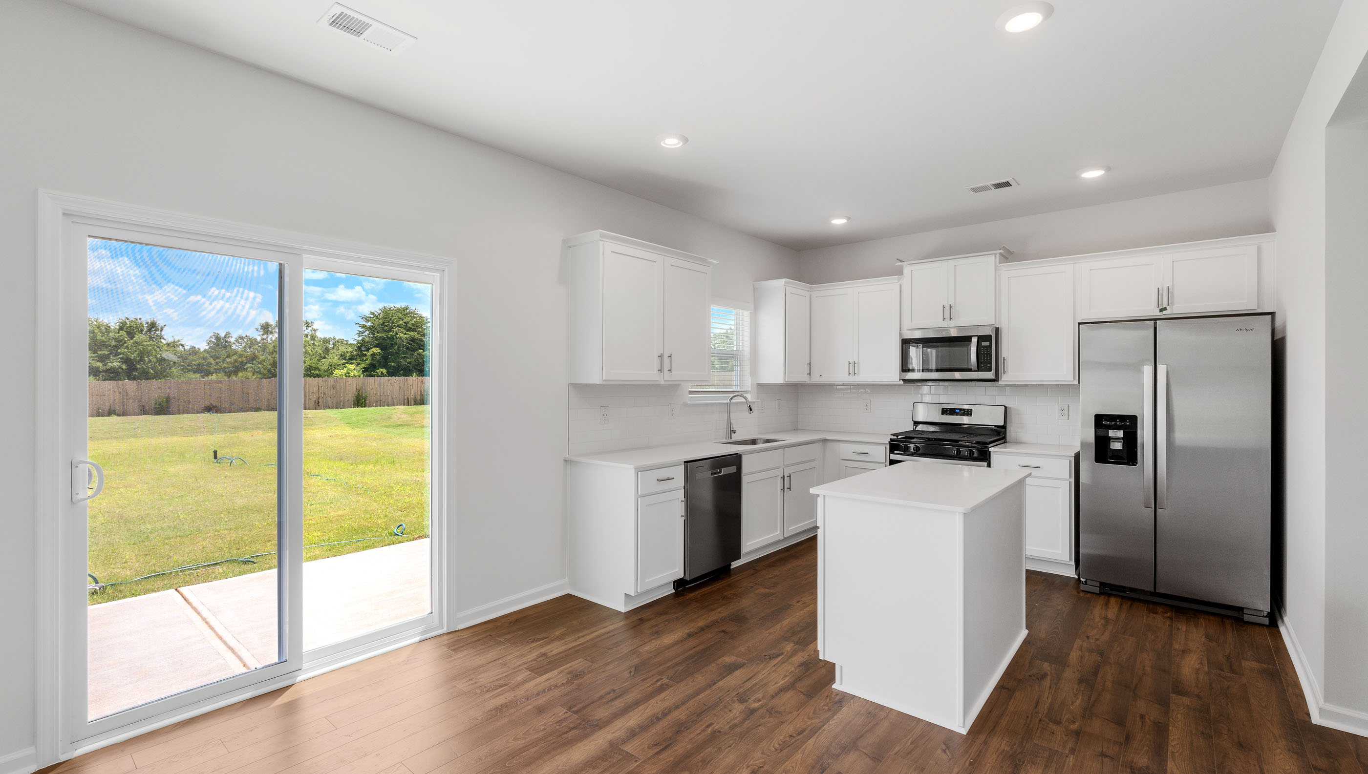 Kitchen with island and granite countertops.