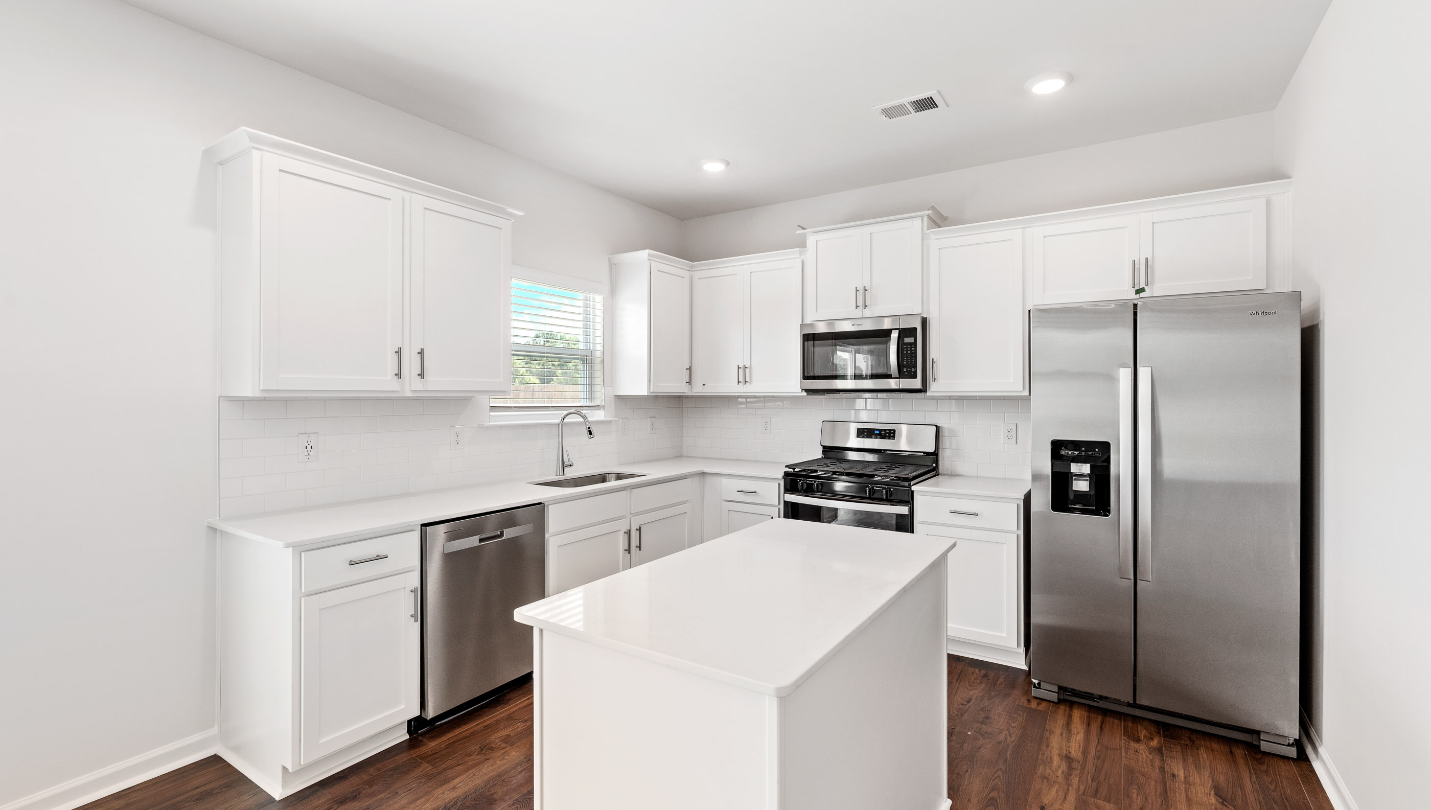 Kitchen with island and granite countertops.