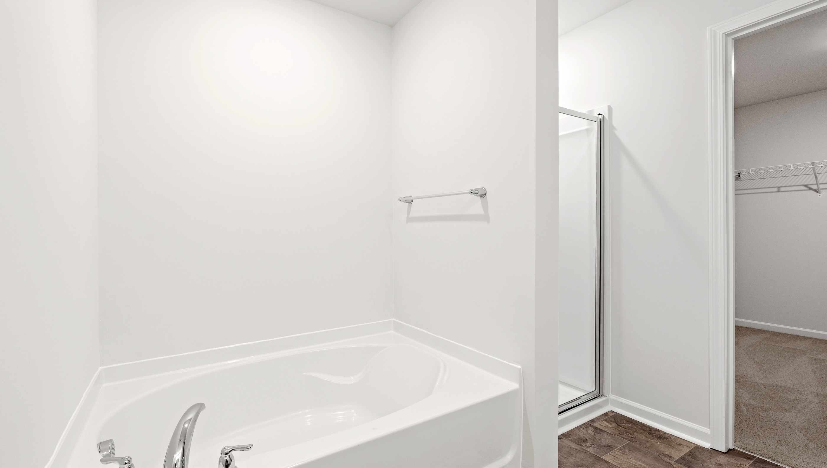 Primary bathroom walk in shower and garden tub.