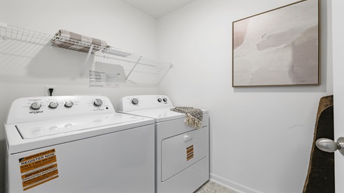 Laundry room with shelf.