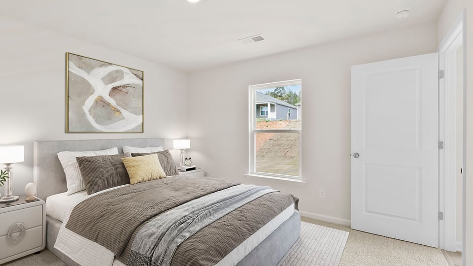 Bedroom with carpet and window.