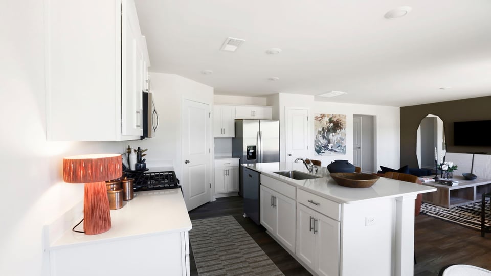 Kitchen and island with quartz countertops and stainless steel appliances.