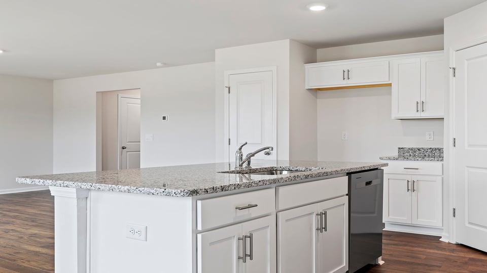 Kitchen with island and granite countertops.