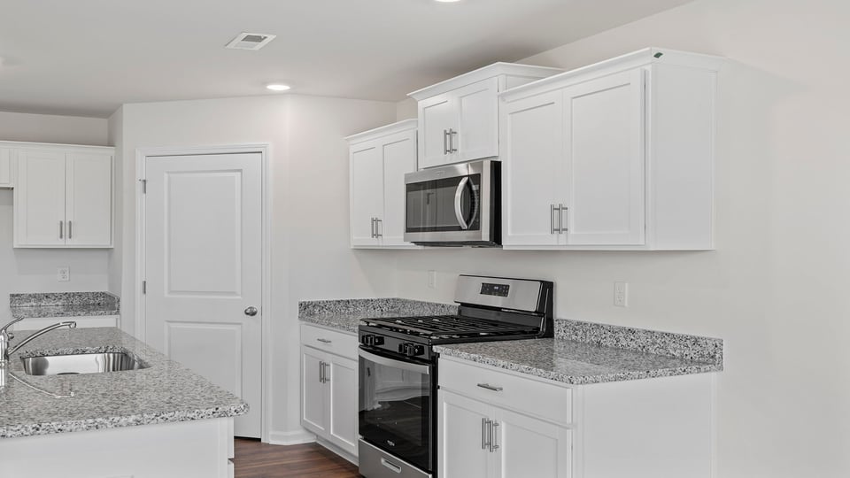 Kitchen with granite countertops and stainless steel appliances.