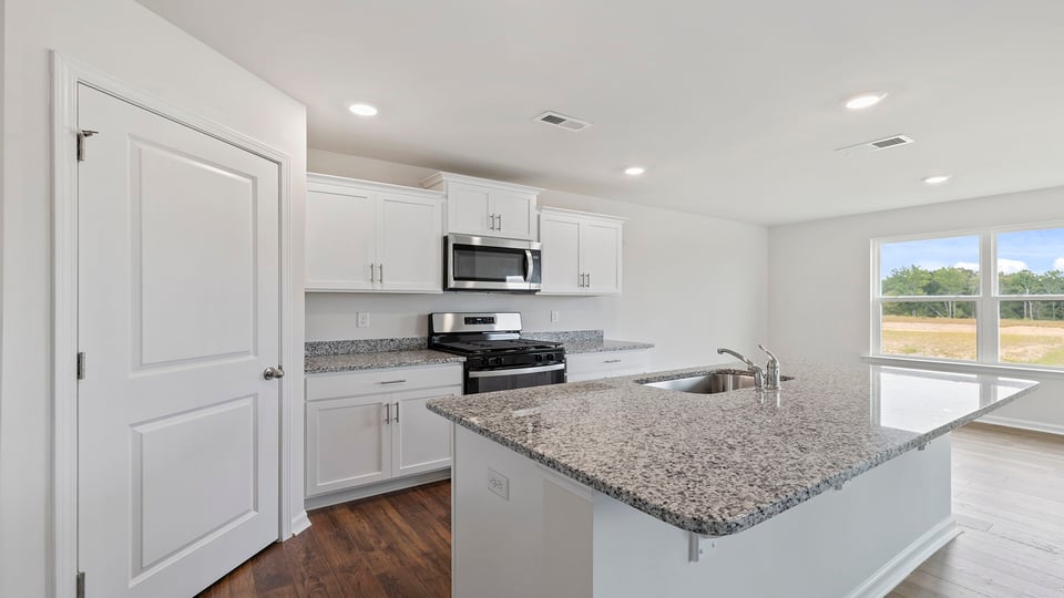 Kitchen with island and granite countertops.