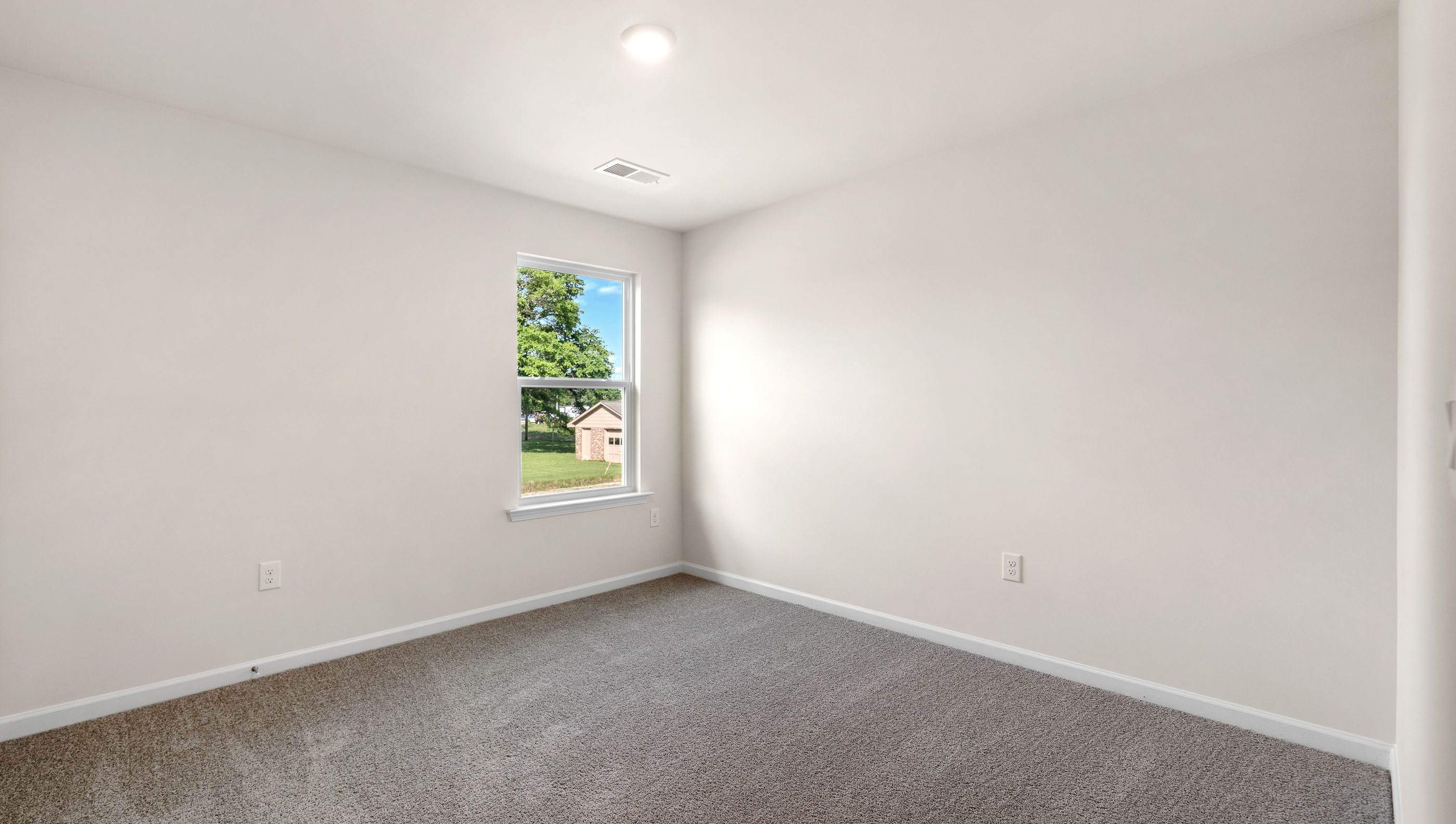 Bedroom with carpet and window.