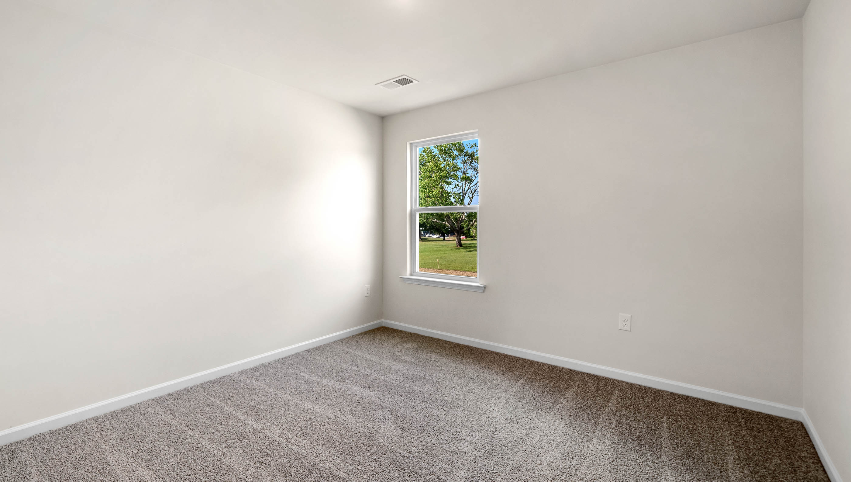 Bedroom with carpet and window.