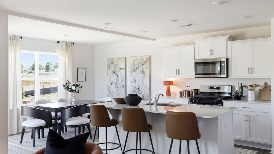 Kitchen and island with quartz countertops and stainless steel appliances.