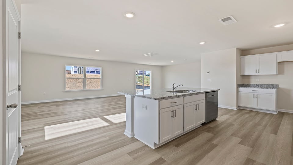 Kitchen and island with quartz countertops.