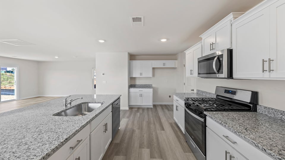 Kitchen and island with quartz countertops.