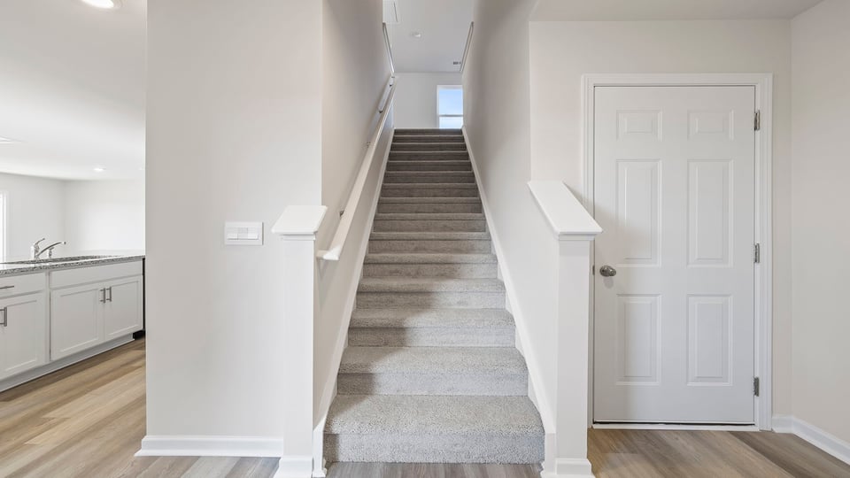 Carpeted stairs to second level.