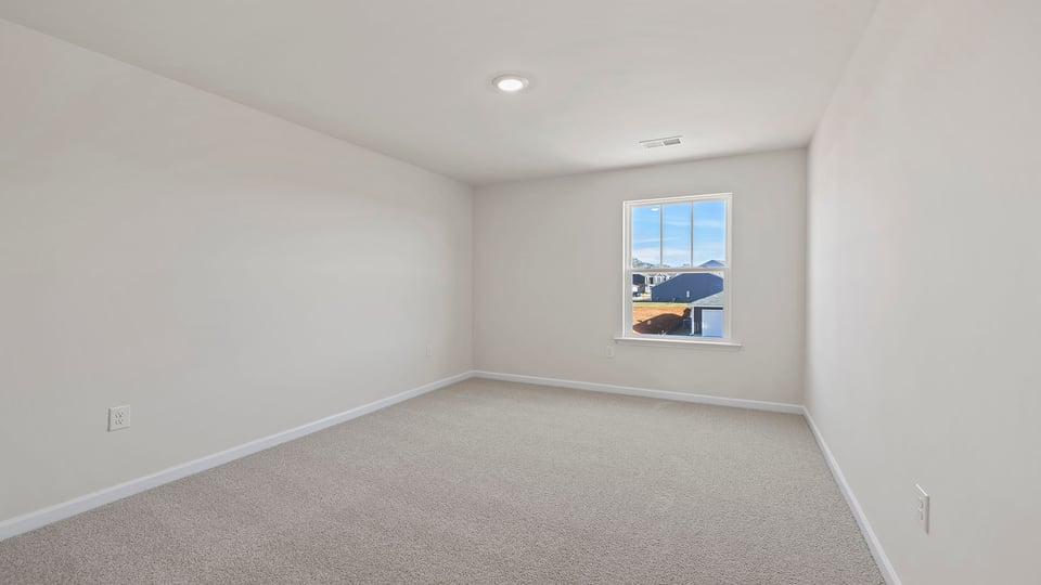 Loft area with carpet and window.