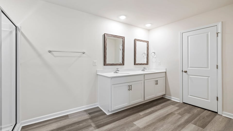 Bathroom with vanity and walk in shower.