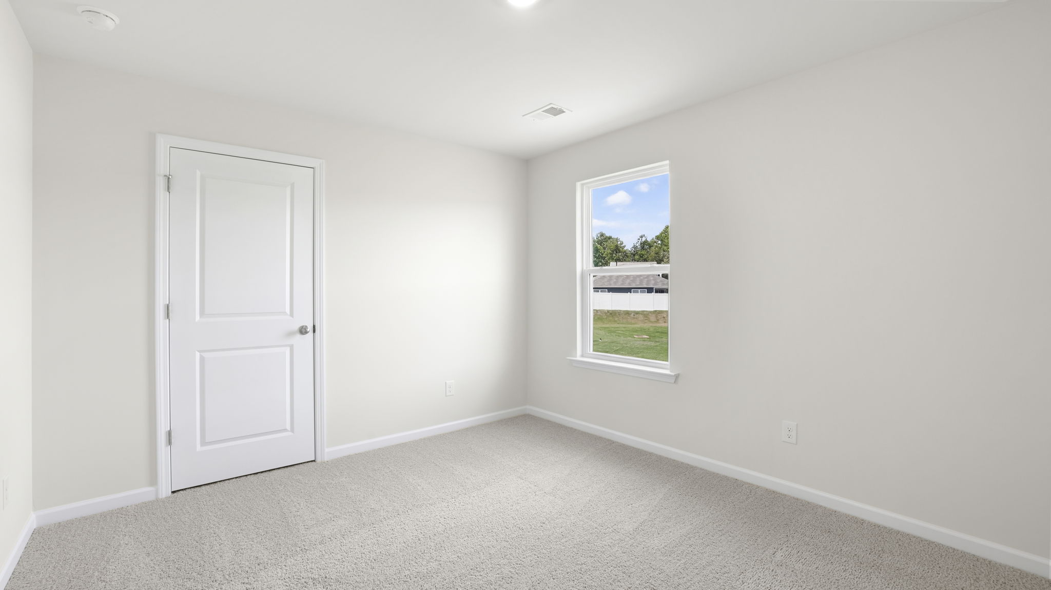 Bedroom with window and carpet.