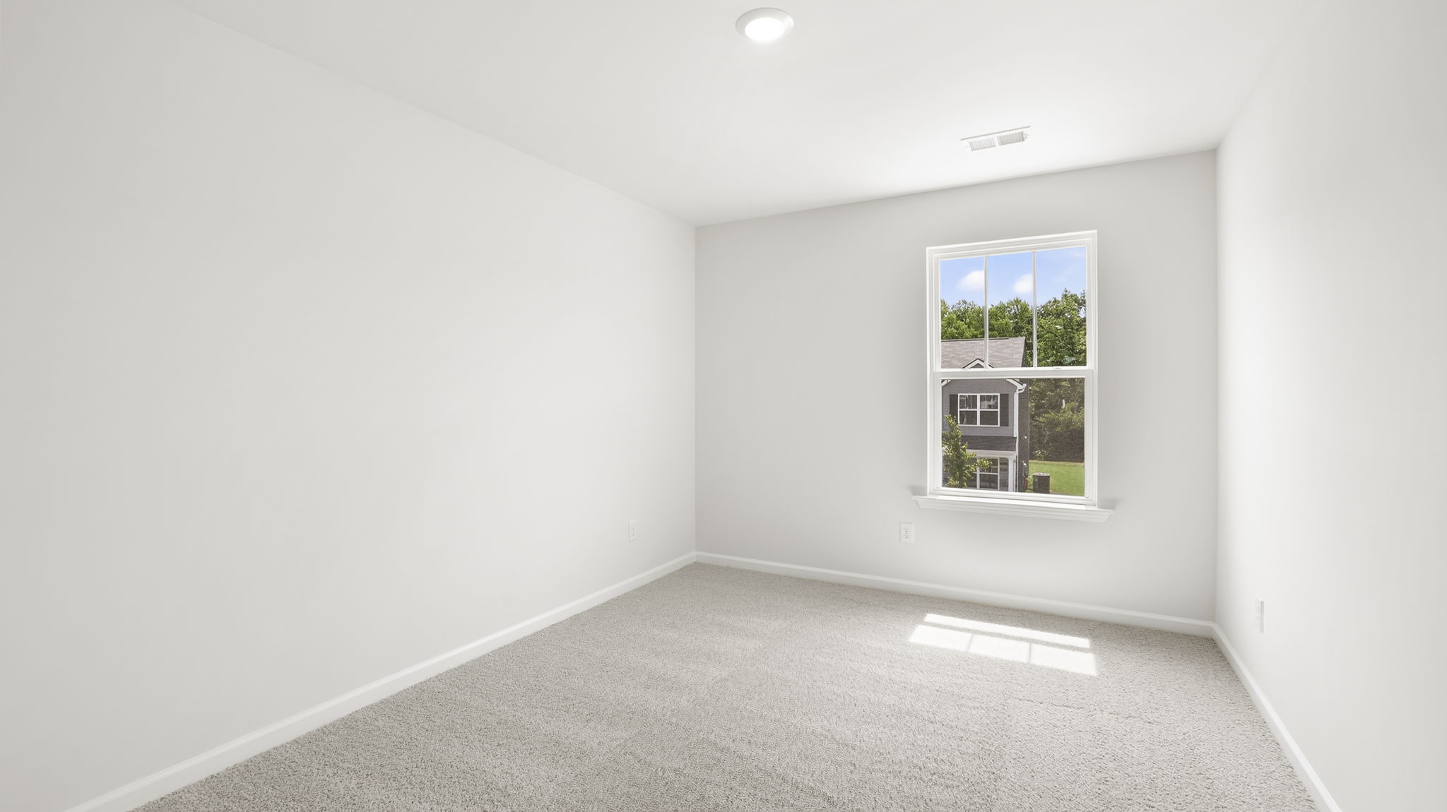 Bedroom with window and carpet.