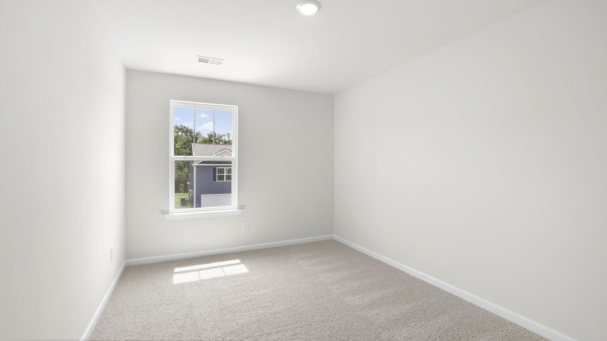 Bedroom with window and carpet.