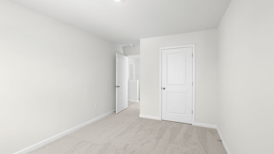 Bedroom with carpet and window.