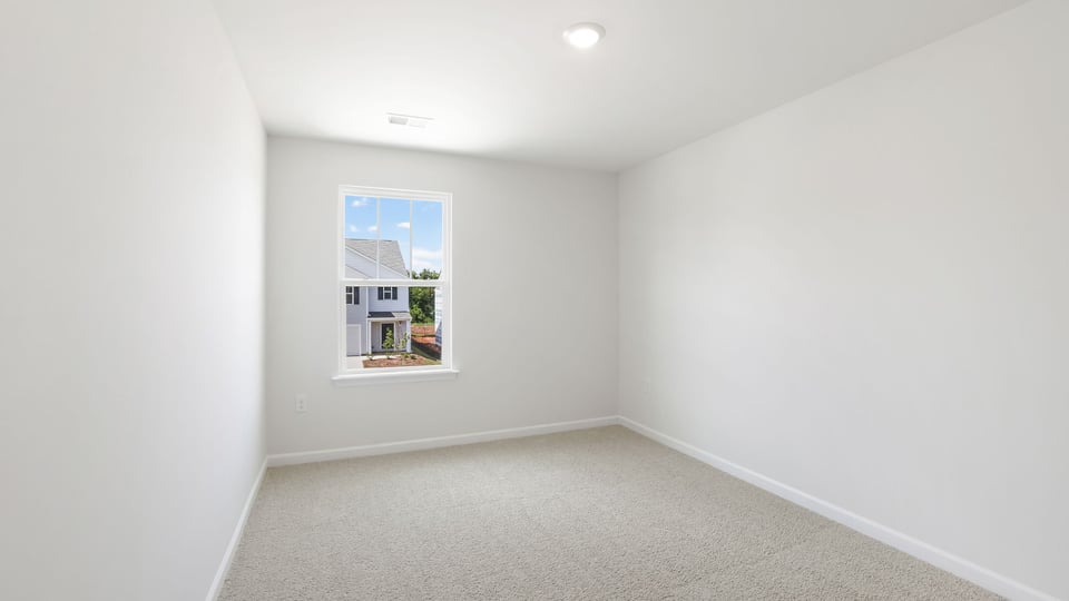 Bedroom with carpet and window.