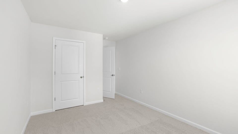 Bedroom with carpet and window.