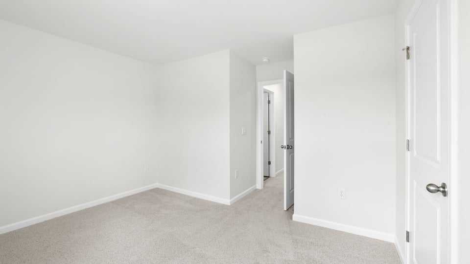 Bedroom with carpet and window.