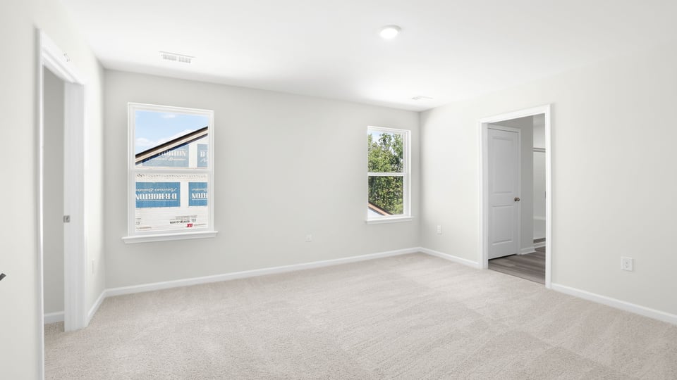 Bedroom with carpet and window.