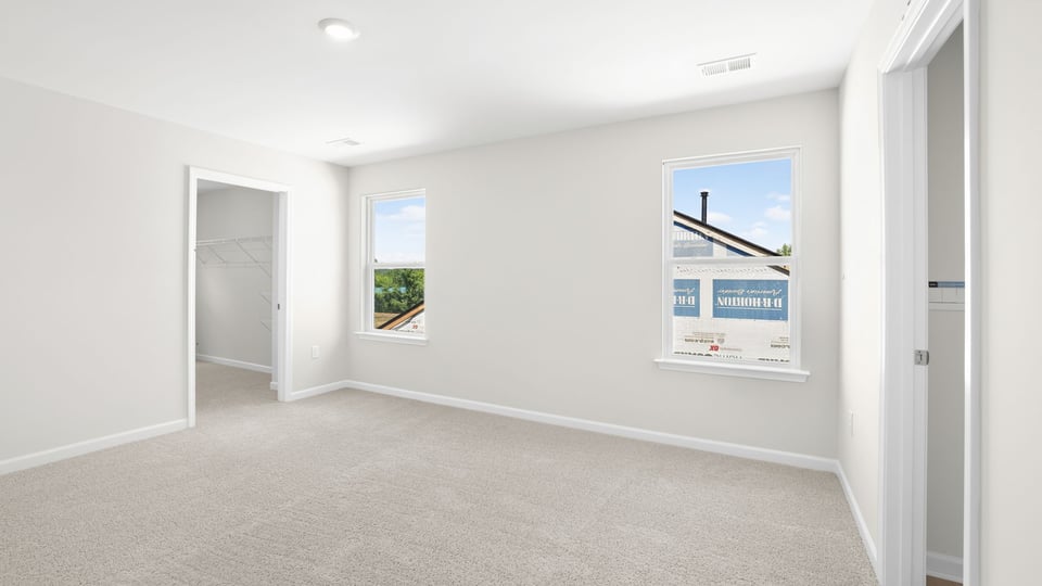 Bedroom with carpet and window.