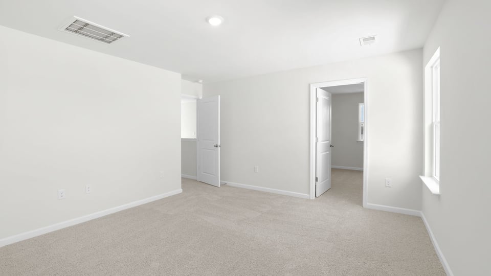 Bedroom with carpet and window.