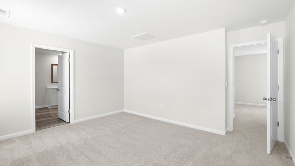 Bedroom with carpet and window.