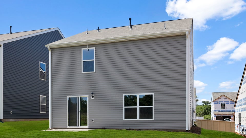 Exterior of home with large backyard.