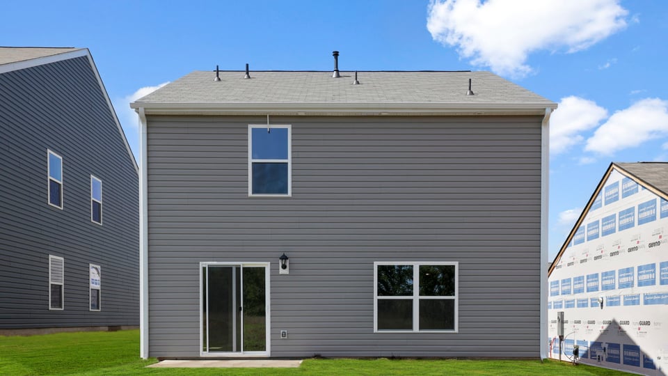 Exterior of home with large backyard.