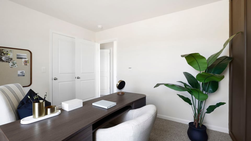 Bedroom with carpet and window.