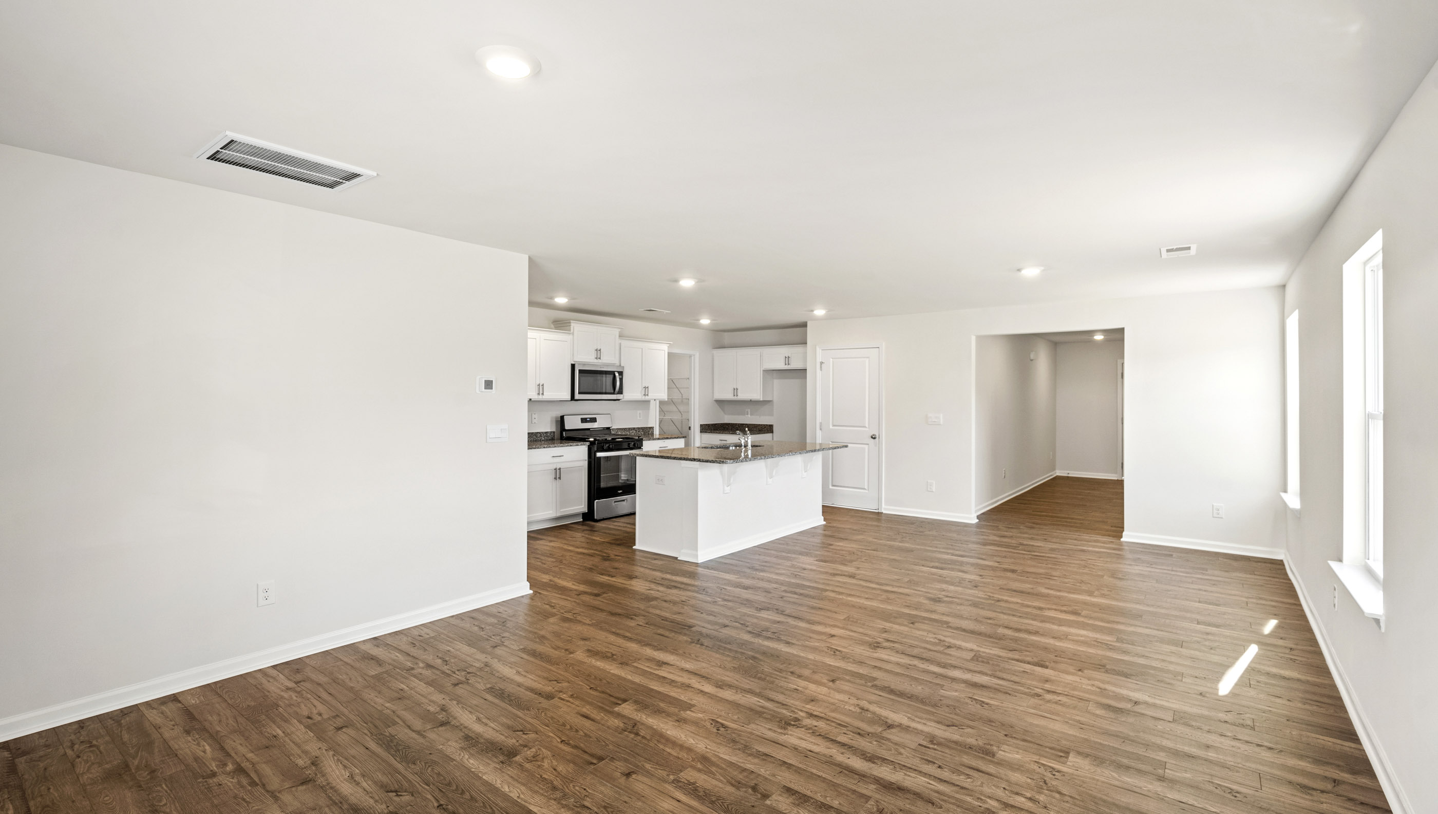 Living room facing kitchen and dining room.