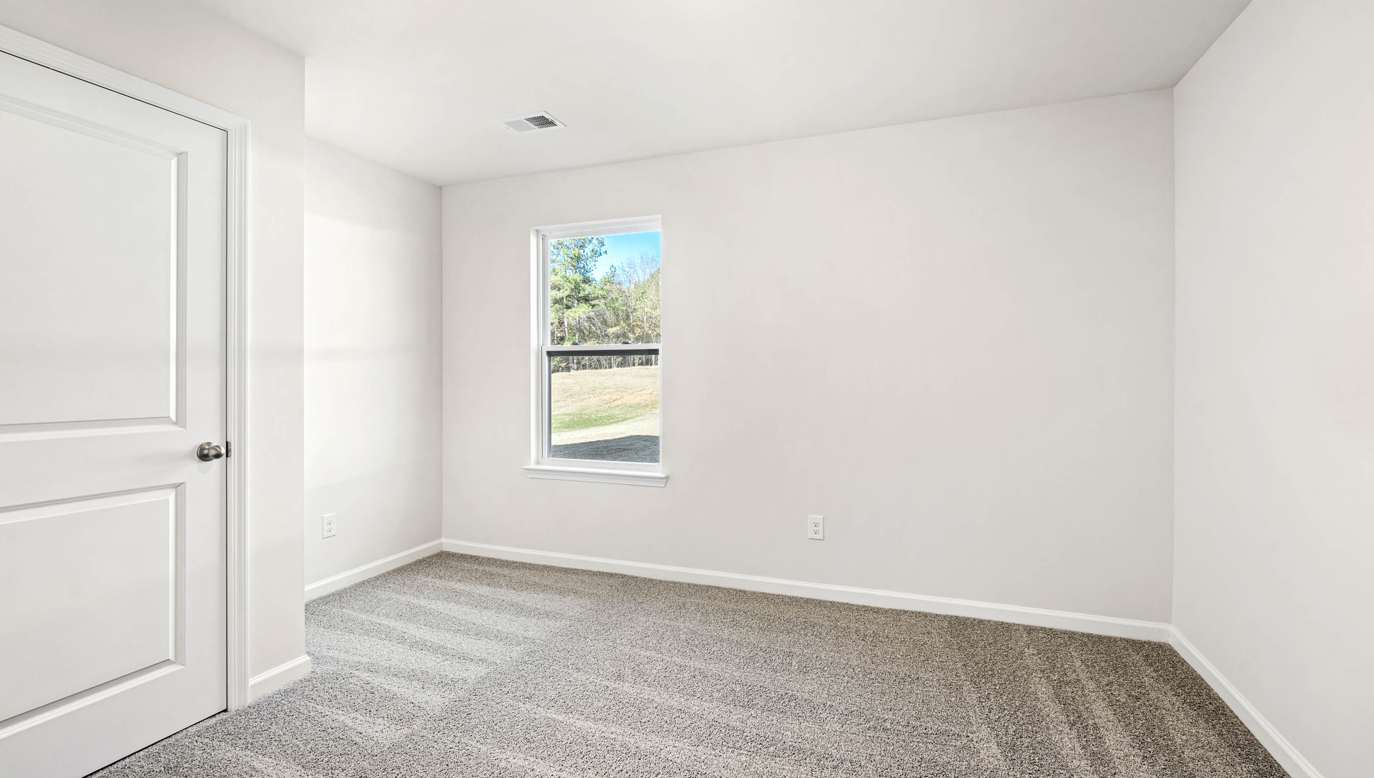 Bedroom with carpet and window.