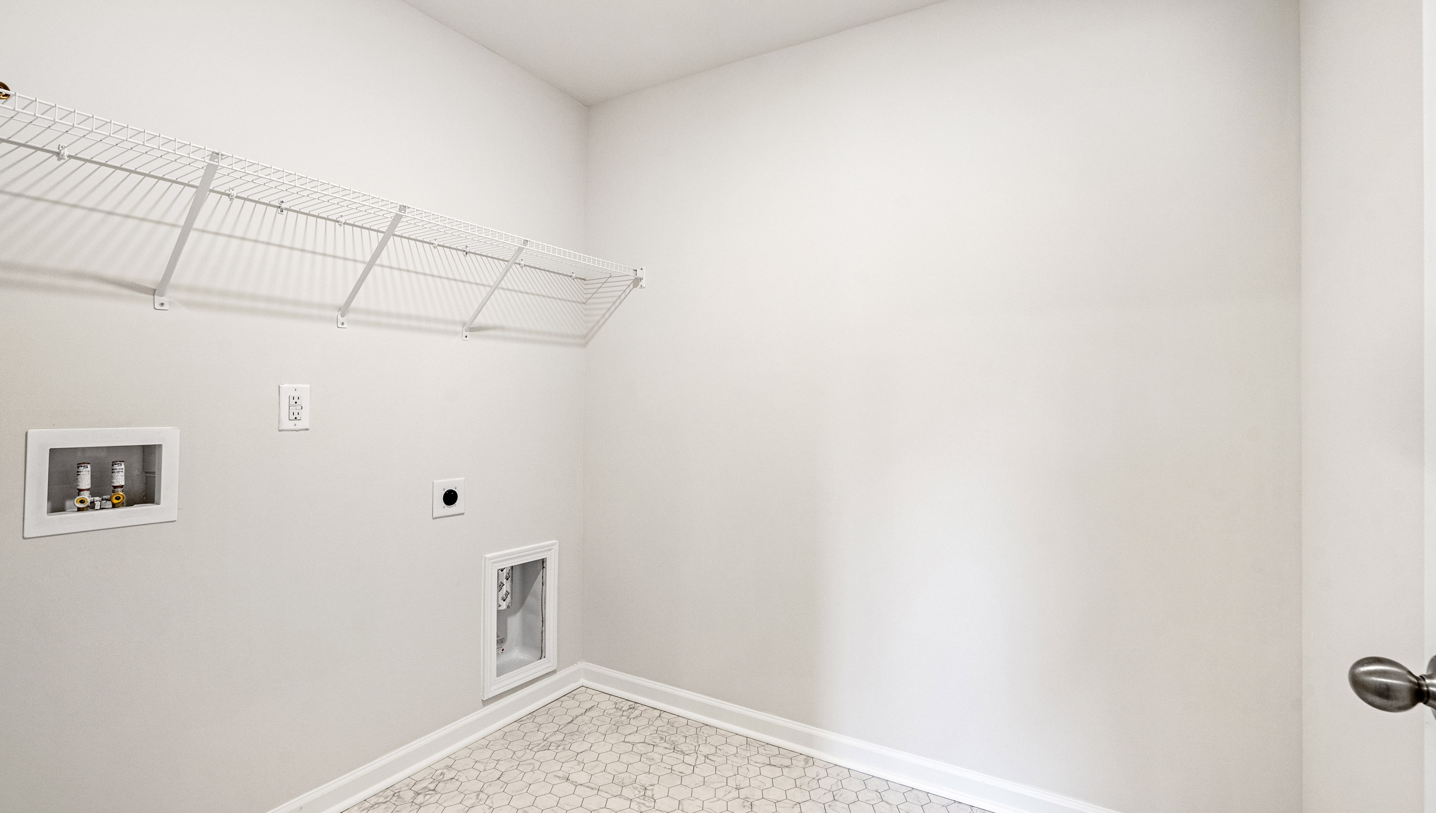 Walk in laundry with shelves.