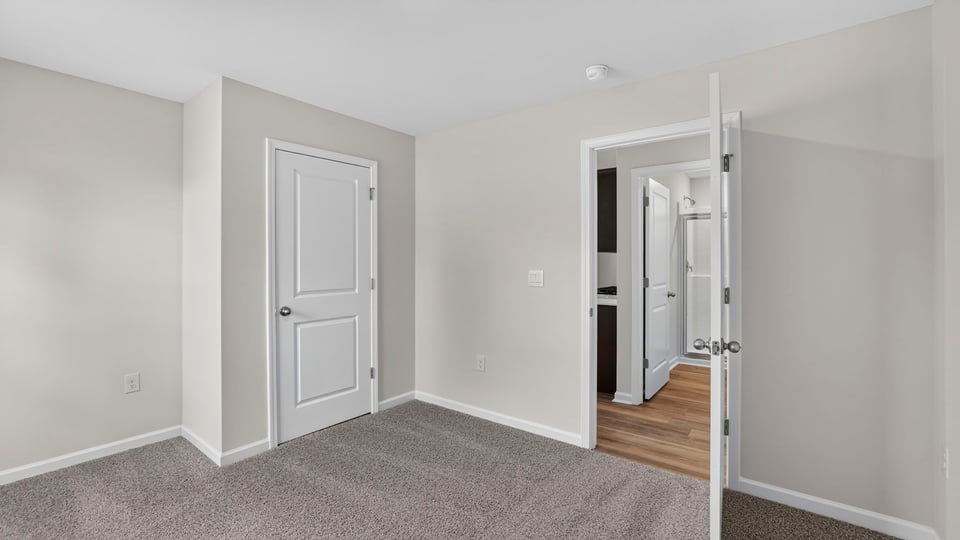 Bedroom with carpet and window.