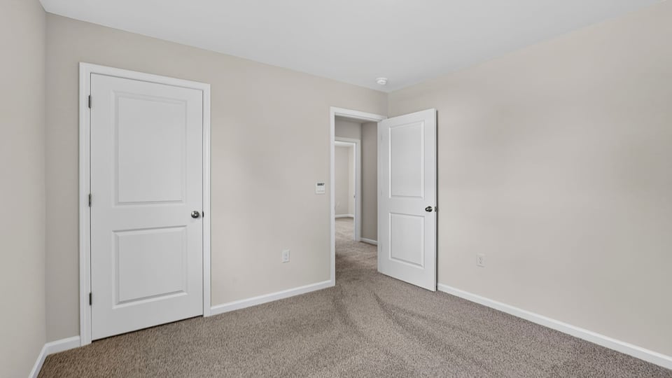 Bedroom with carpet and window.
