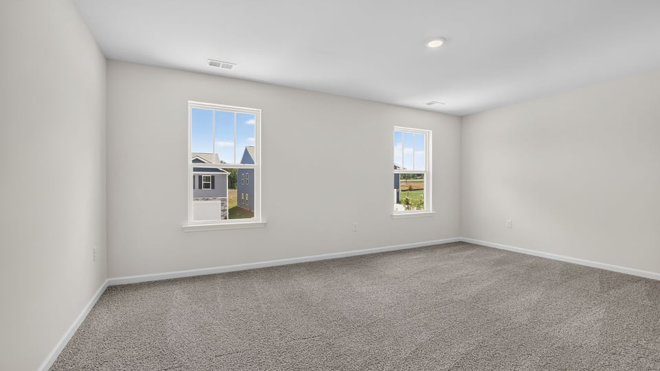 Bedroom with carpet and window.
