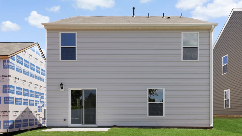 Exterior of home with large backyard.