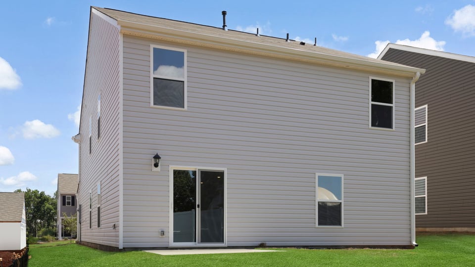 Exterior of home with large backyard.