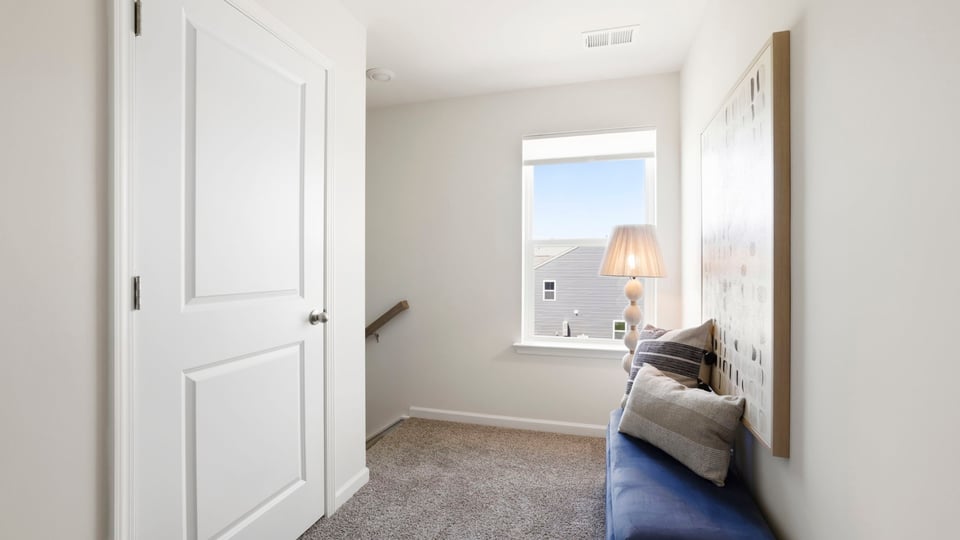 Loft area upstairs with carpet.