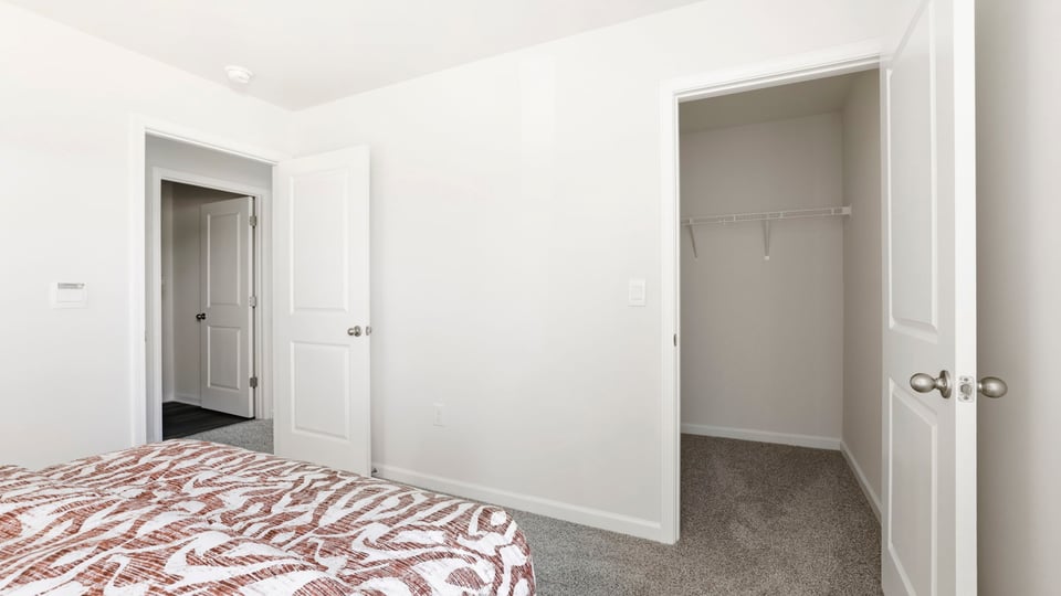 Bedroom with carpet and window.