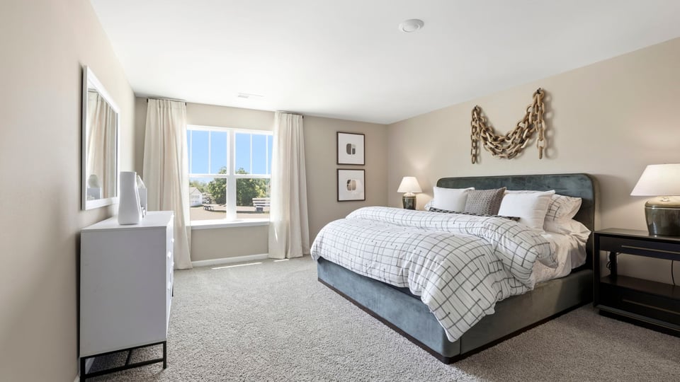 Bedroom with carpet and window.