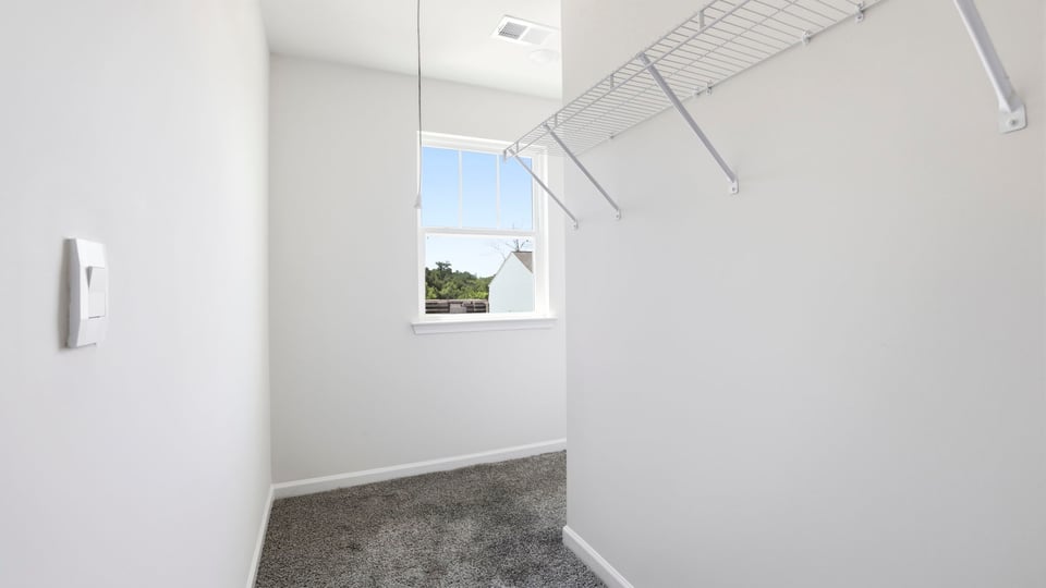 Closet with hanging storage racks.