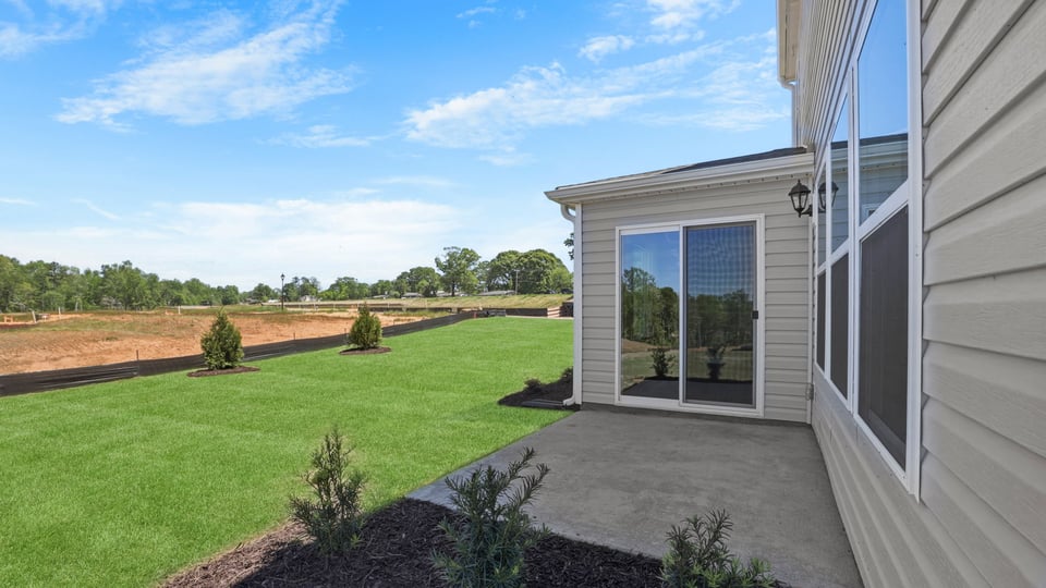 Back exterior of home with small patio.