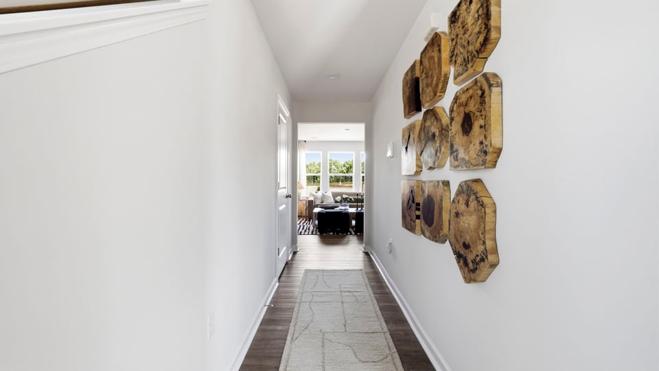 Hallway into home with view of rooms.