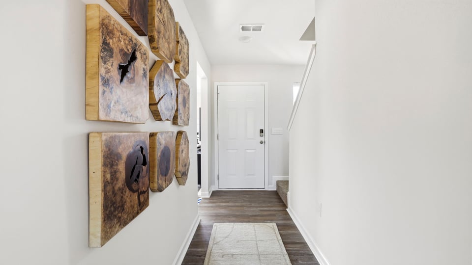 Hallway into home with view of rooms.